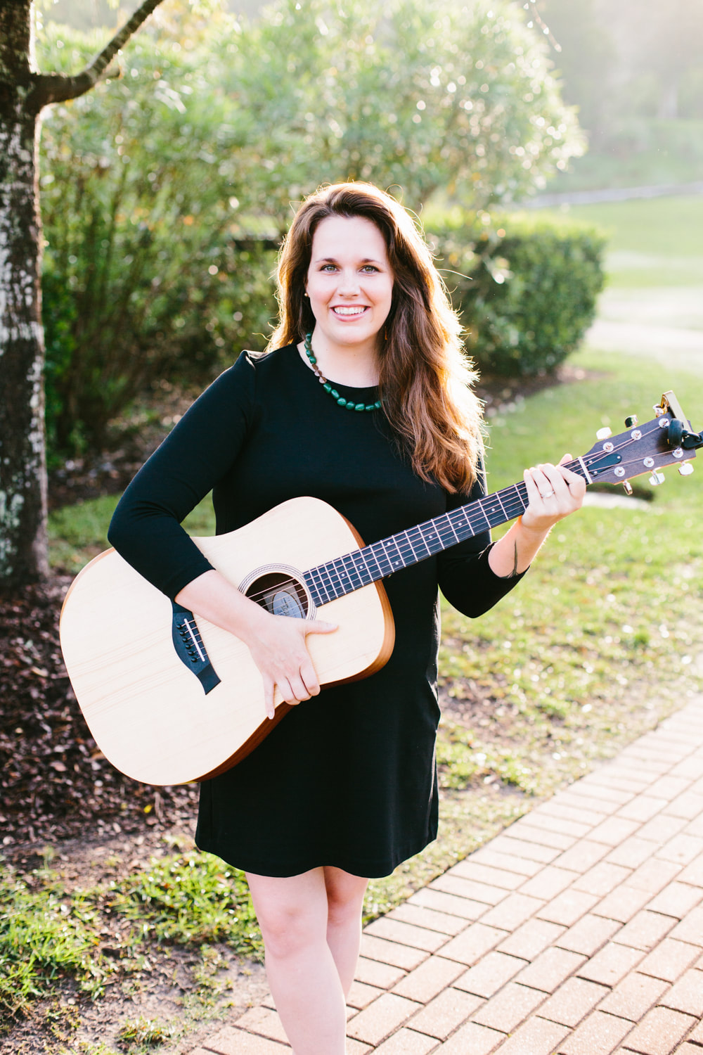 Claire Littlejohn holding guitarist. Claire is a music therapist and instructor with SC Music Lessons LLC