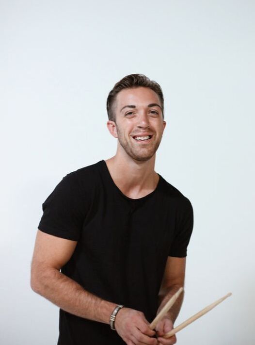 Ian Giancursio / Ian James - holding drum sticks, composer and instructor